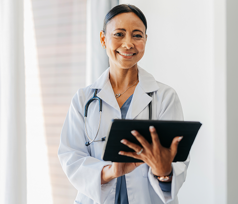 Smiling physician with a laptop